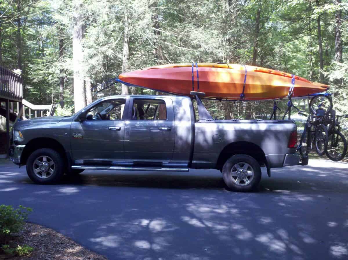 Silver Truck with Orange Kayak on rack
