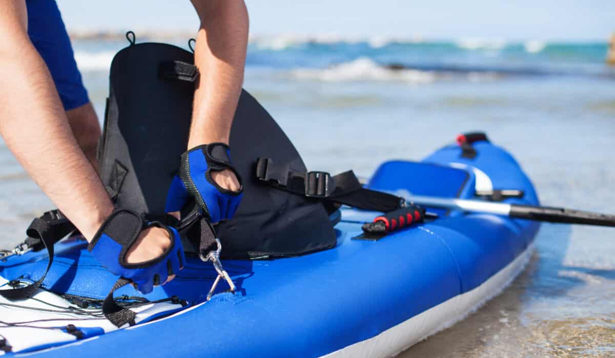 Man preparing kayak at shore of the beach beach