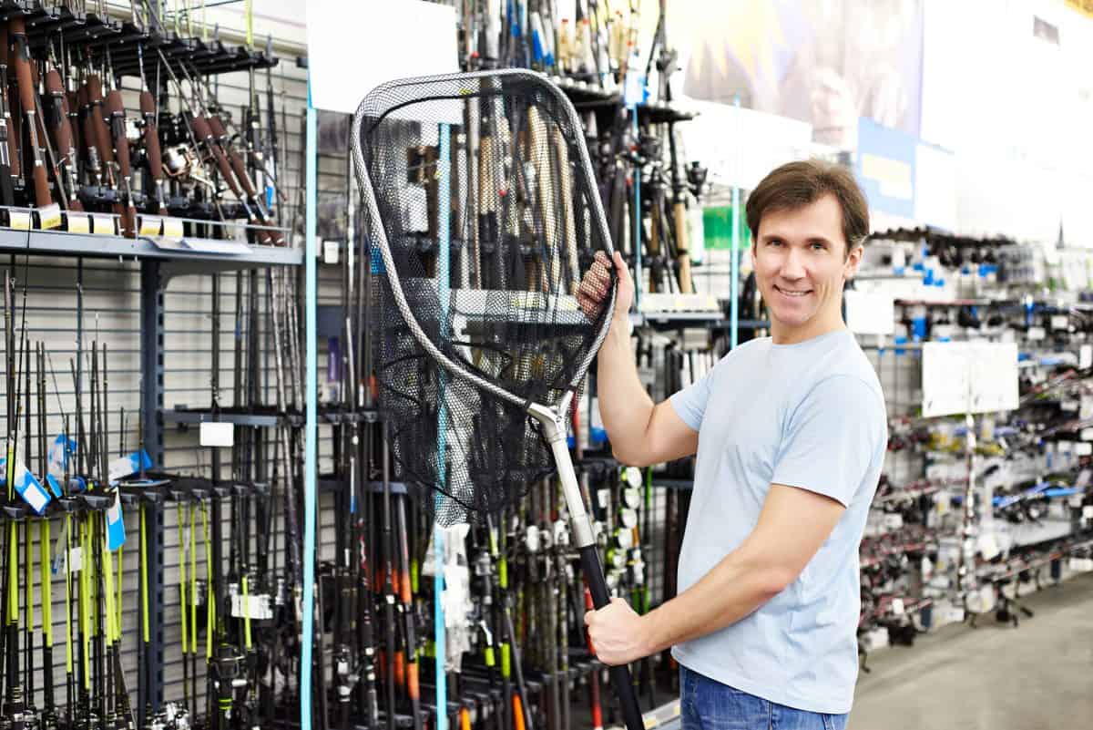 Man chooses landing net for fishing