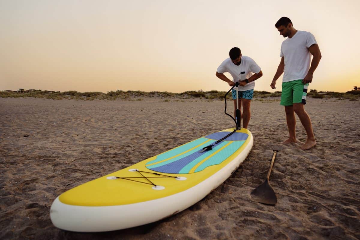 Man inflating a inflatable stand up paddle board
