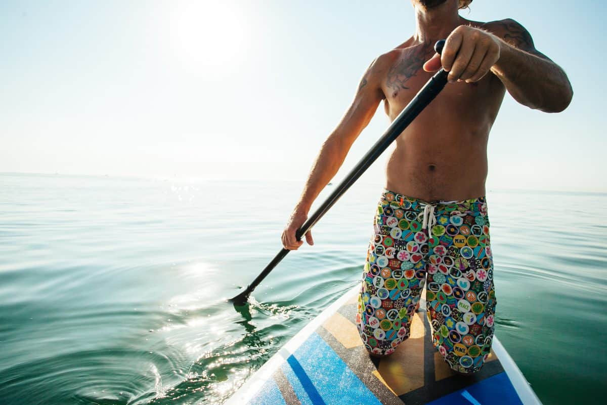 Man kneeling on paddle board