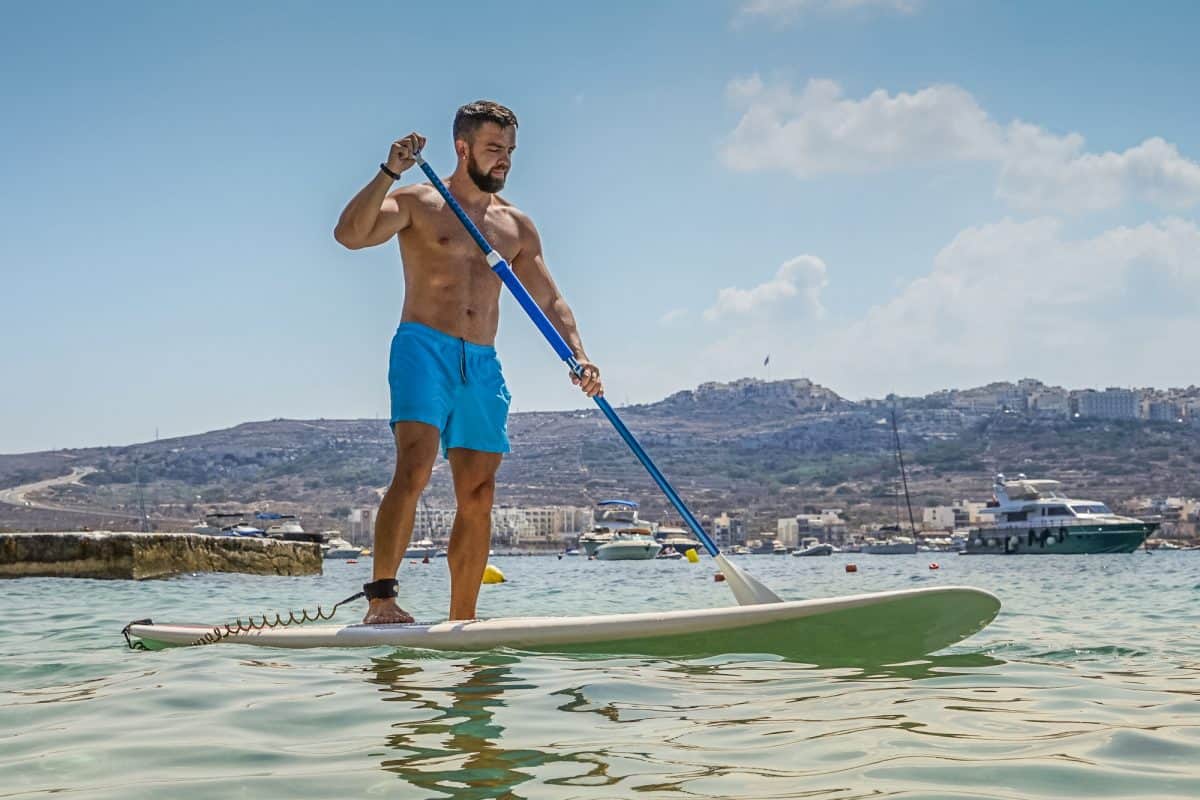 Man on paddle board with knees slightly bent