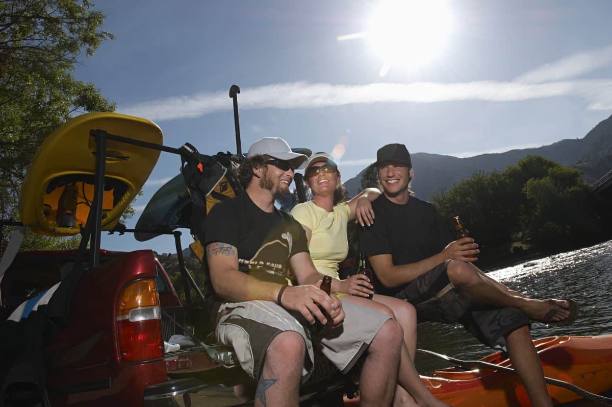 Men drinking beer after kayaking trip