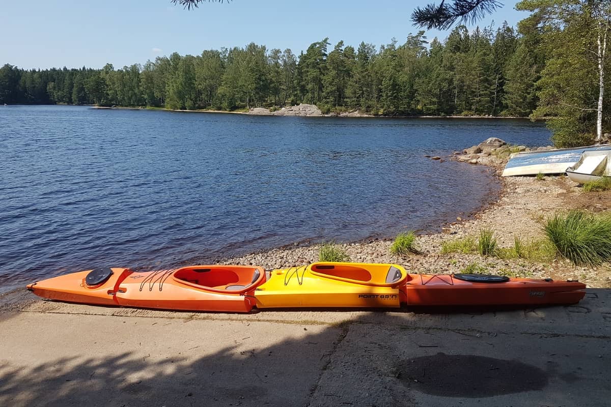 Modular sit inside kayak on the bank next to water