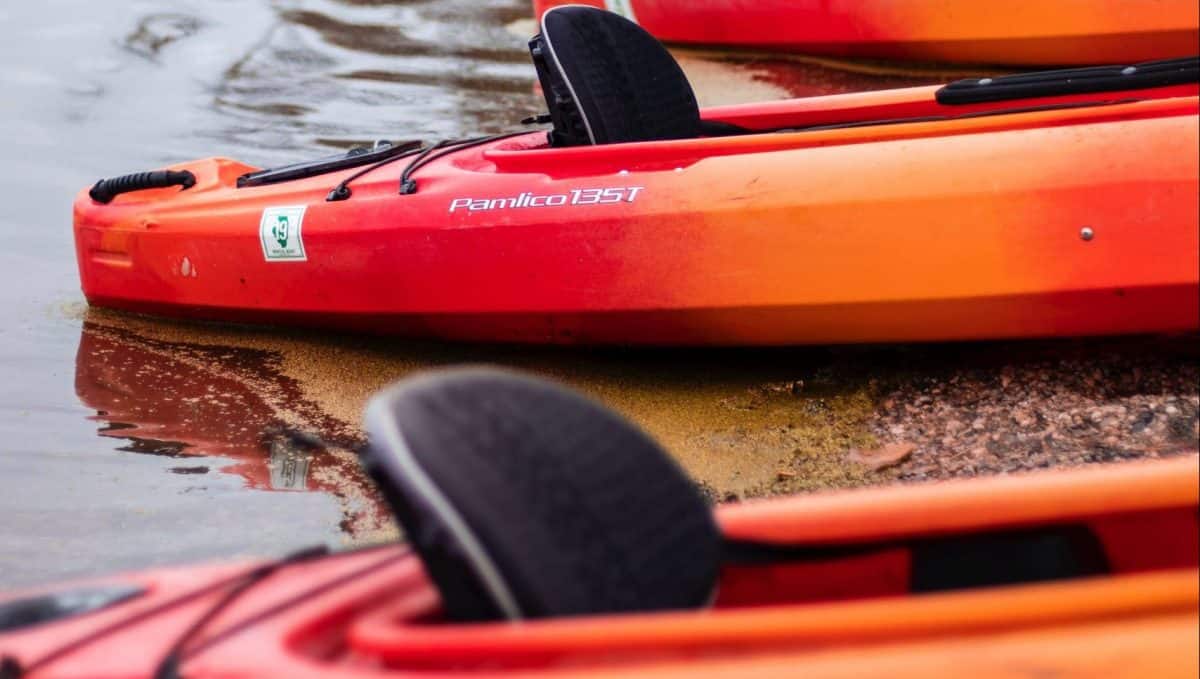 Two red Kayak with black seats
