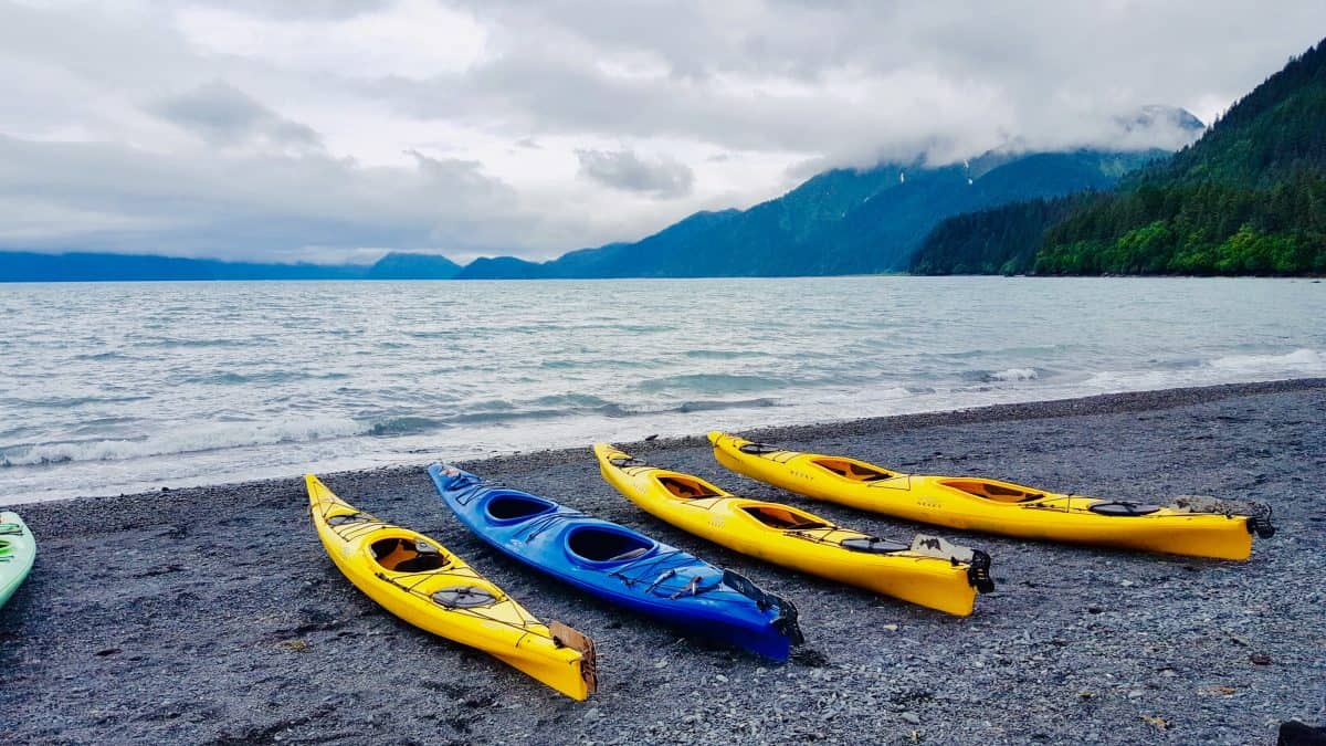 4 yellow kayaks on beach - How to choose a kayak for the ocean