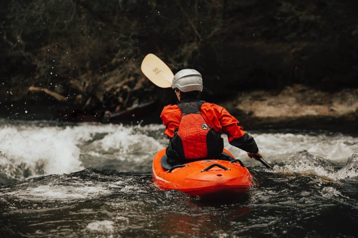 kayaker paddles best kayak for river into oncoming rapids