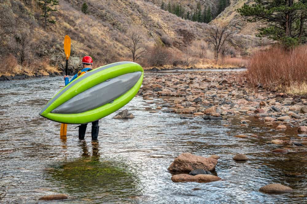 Man carrying lightweight kayak
