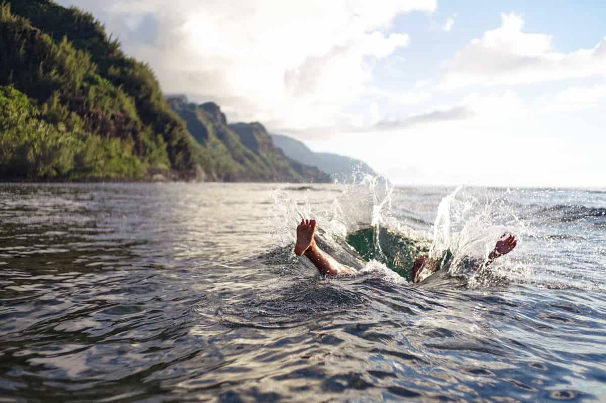 Big guy failing out of kayak into sea