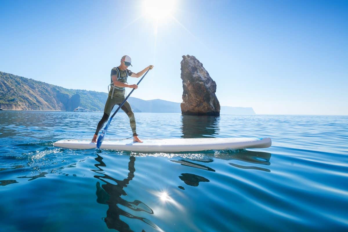 Stand up paddle boarding -man floating on a sup board in sea