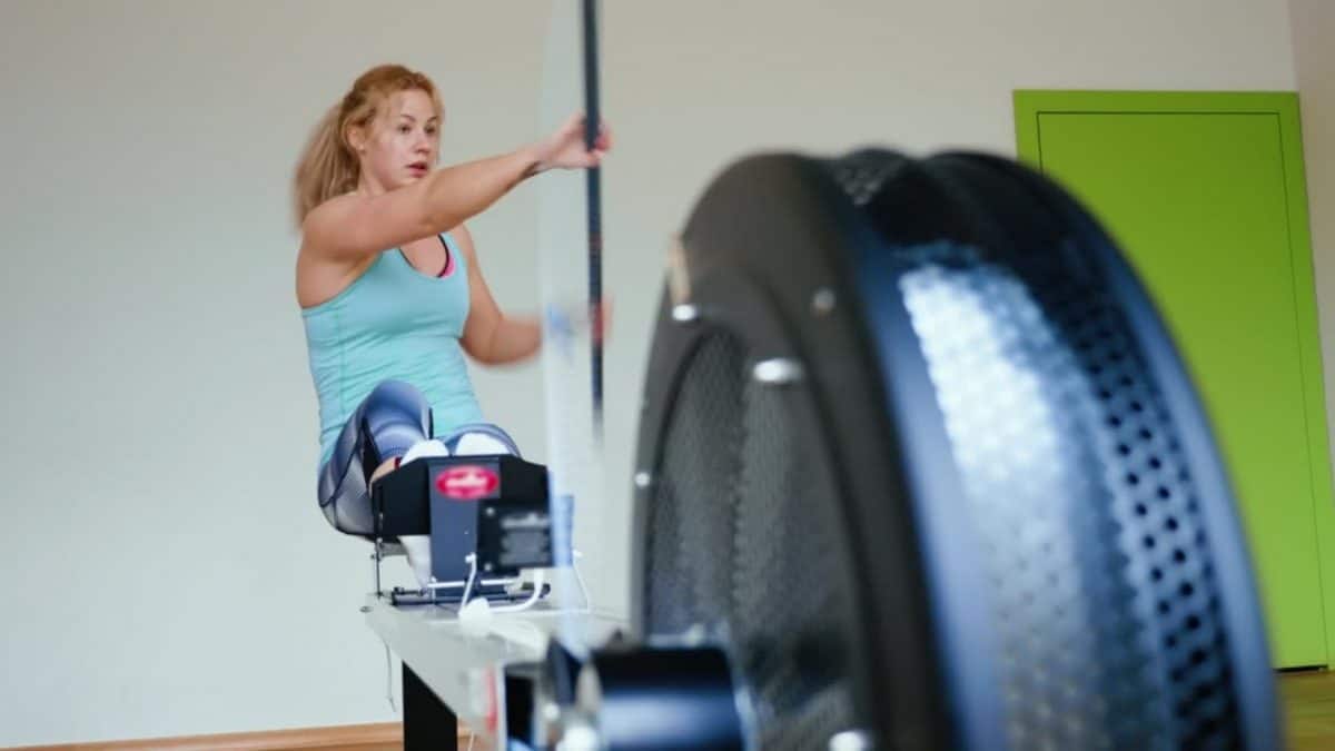 Woman on a rowing machine adapted for kayking