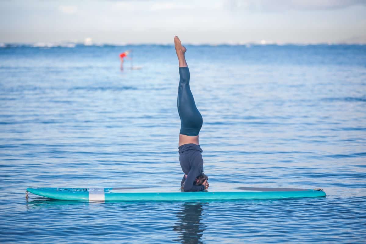 Young woman in SUP Yoga practice